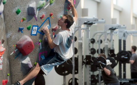 Student climbs the rock wall