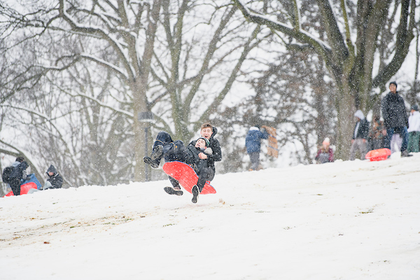 photo of students sledding down Slayter Hill